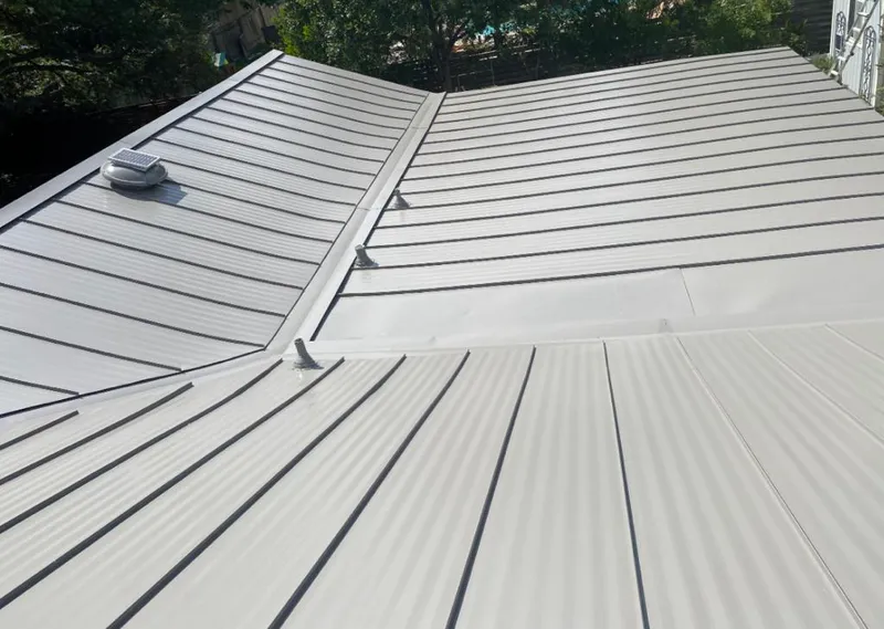Solar attic fan installed on a metal roof for Roof Ventilation in Indian Trail